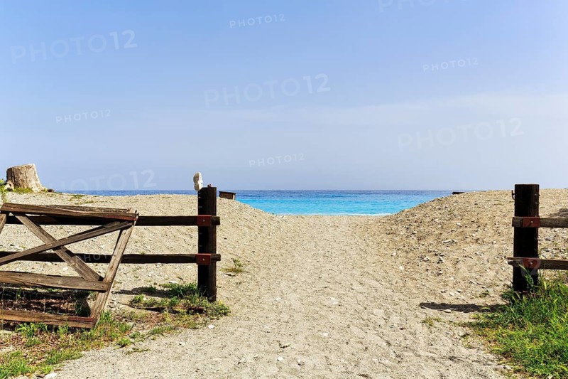 Beach access, sandy path with fence, single lost shoe, turquoise Mediterranean, Leonidi, Leonidio, Tsakonia, Arcadia, Peloponnese, Greece