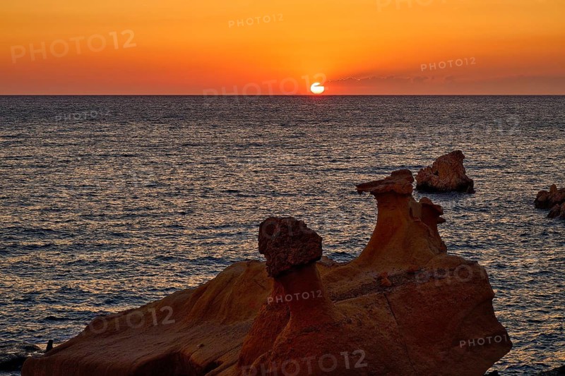Red sunset over calm sea and distinctive rock formations, Aspragremna, White Cliffs, Mavorspilia Beach, Beach, Kimolos Island, Kimolos, Cyclades, Greek Islands, Greece