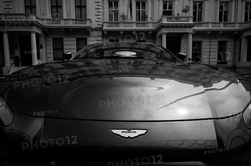 Logo, Aston Martin sports car parked in front of IMPERIAL College, University and Technical College, Victorian houses reflected in the windscreen, London, black and white, South Kensington, London, England, Great Britain