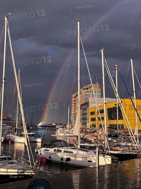 Marina with sailboats and rainbows against dark grey sky, Kalmar, Kalmar Län, Sweden