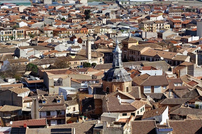 Cityscape, dense rows of houses with traditional brown tiled roofs, chapel, view from above, old town of Consuegra, Toledo province, Castilla-La Mancha, Spain
