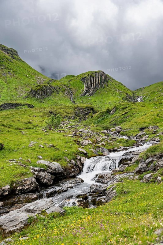 Bergbach Sousbach flows through picturesque green mountain landscape, Bernese Alps, Bernese Oberland, Switzerland
