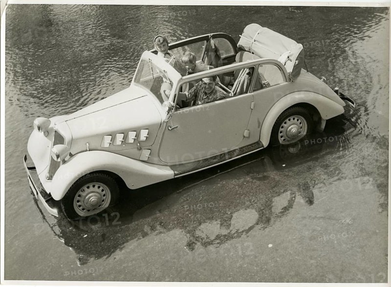 Adler, vintage car, OKW, in water, commercial shot, A convertible with occupants standing in shallow water, a scene full of fun Karl Theodor Gremmler, 1935