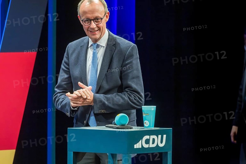 Election event of the CDU party for the Bundestag elections with top candidate Friedrich Merz. Portrait in front of the German flag and the flag of the European Union. Singen am Hohentwiehl. Baden-Württemberg, Germany