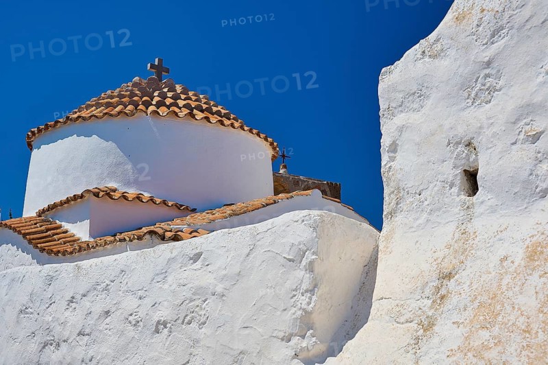 White church with red tiled roof and cross on top, in front of a clear blue sky, Chora, Old Town, Patmos, Dodecanese, Greek Islands, Greece