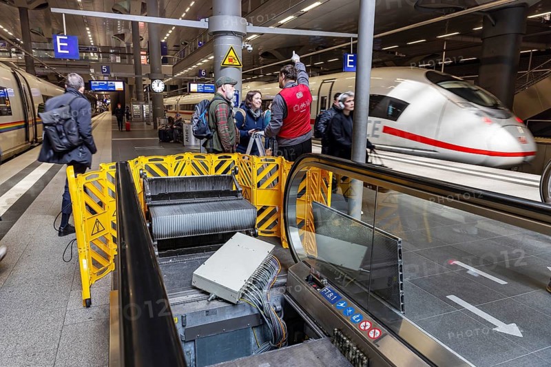 Berlin Central Station. A lot of escalators are broken. Travelers must either take detours or climb stairs with their luggage. Travelers on the platform with ICE. Berlin, Germany