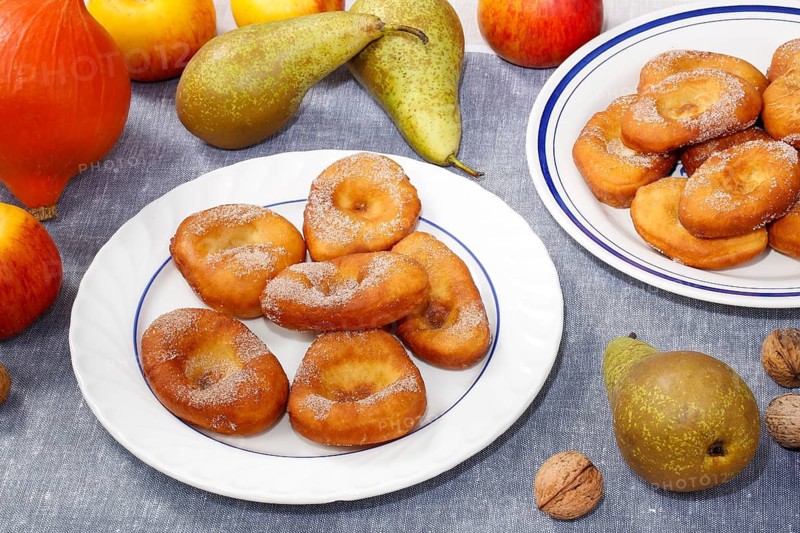 Swabian cuisine, harvest cakes, dessert, dessert, fat baked goods, doughnuts, fried food, lard noodles, arranged on a plate, grandmother's kitchen, regional, home cooking, typical Swabian, classic recipe, traditional cuisine, food photography, autumn atmosphere, apples, pears, nuts, still life, studio, Germany