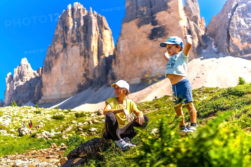 Mother and son enjoying hiking in the italian alps near tre cime di lavaredo in the dolomites