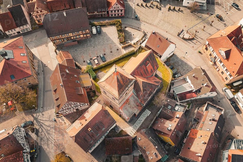 Aerial view of a historic old town with half-timbered houses and a centrally located church, Ötisheim, Enzkreis, Germany
