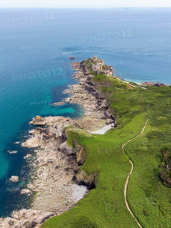 Aerial view of the historic rock castle Fort la slat, Château de la Roche Goyon on a rocky headland on the Emerald Coast, surrounded by the turquoise Atlantic Ocean, Plevenon, Côtes-d'Armor department, Brittany region, France