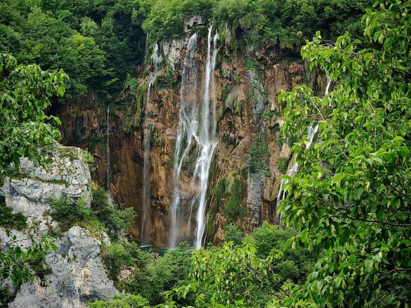 High waterfall surrounded by lush vegetation, Plitvice Lakes National Park, Croatia