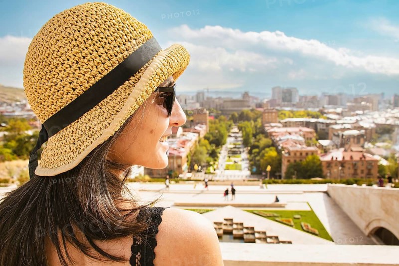 Close up Happy caucasian tourist woman on viewpoint pose enjoy sightseeing Yerevan city landmarks on holidays