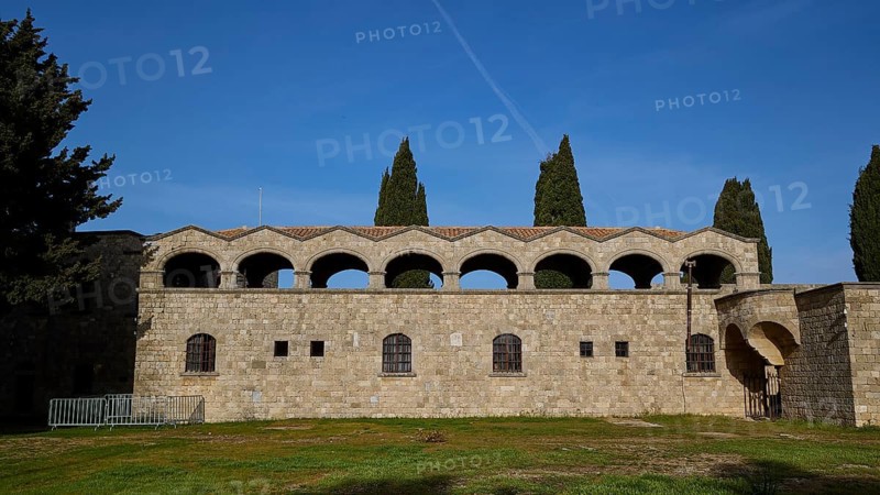 Monastery of Our Lady of Mount Filerimos, historic stone building with arches under a blue sky, Filerimos, hill not far from Rhodes town, Ancient State of Ialyssos, Rhodes, Dodecanese, Greek Islands, Greece