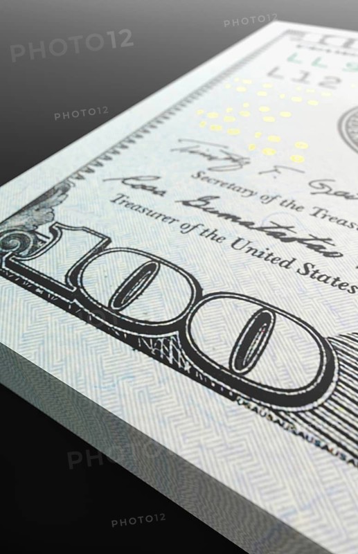 Ten thousand dollar stack of one hundred dollar bills close-up abstact.