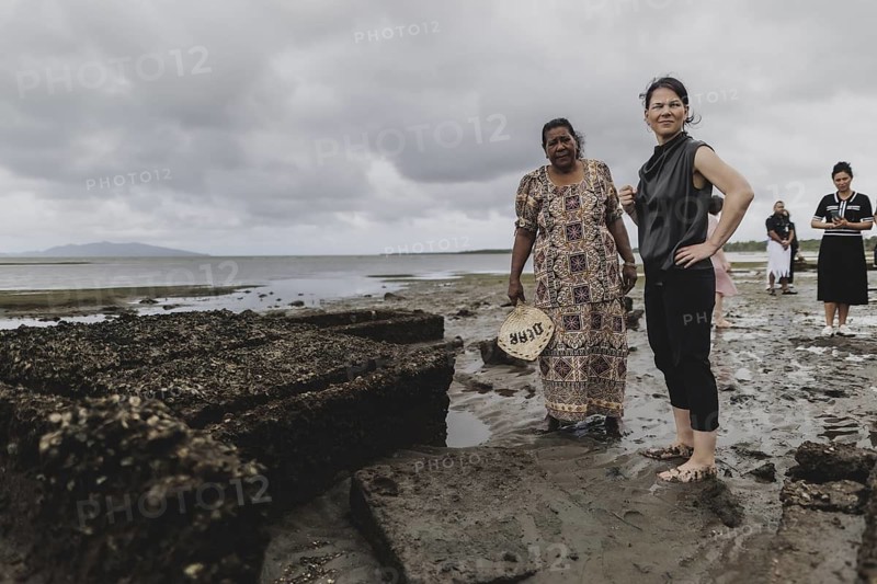 (R-L) Annalena Bärbock (Bündnis 90/Die Grünen), Federal Foreign Minister, and Lavenia McGoon, resident of the Togoru settlement, photographed during a briefing on coastal erosion at a cemetery near the Togoru settlement flooded by rising sea levels, 07.05.2024. Bärbock is travelling to Australia, New Zealand and Fiji for political talks / Photographed on behalf of the Federal Foreign Office