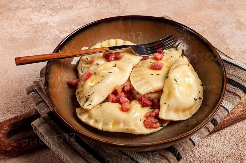 Dumplings, with fried prosciutto, a traditional dish of Polish cuisine, dumplings, top view, close-up, without people