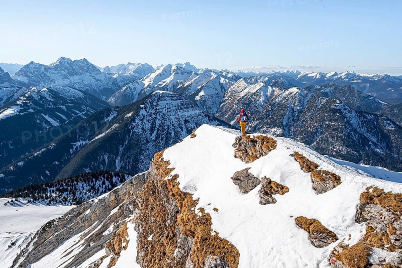 Ski tourers at the summit of Schafreuter, view of snowy mountain panorama, Karwendel, Tyrol, Austria