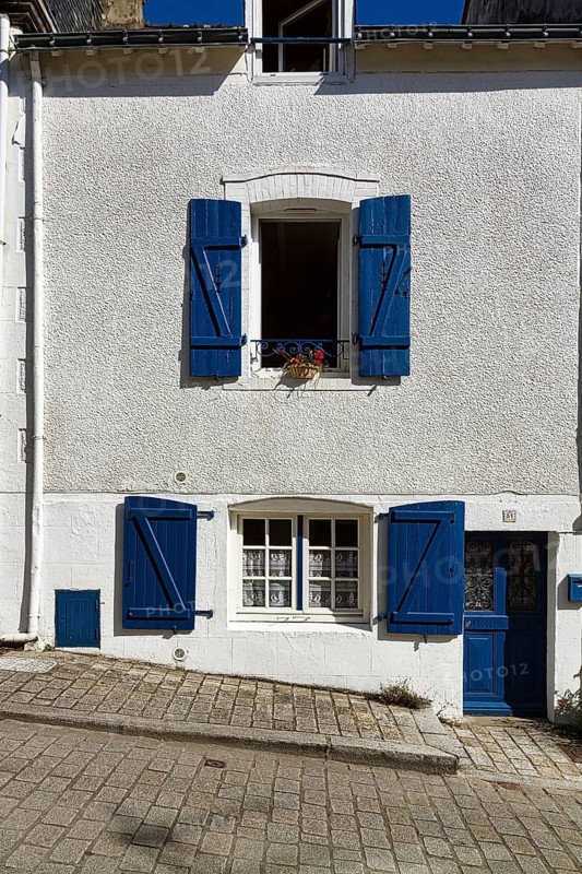 White painted house with blue shutters and blue door on the hillside, Upper Town, Auray, Morbihan, Brittany, France