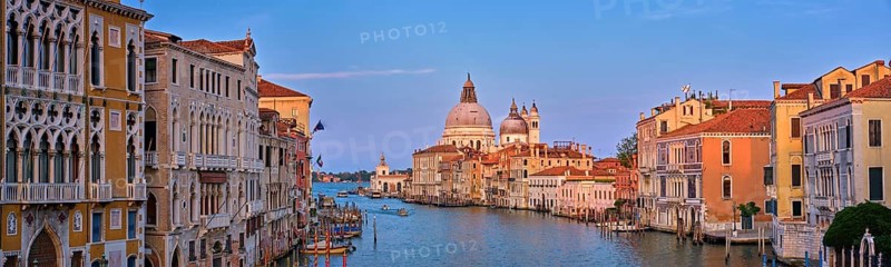 Panorama of Venice Grand Canal with boats and Santa Maria della Salute church on sunset from Ponte dell'Accademia bridge. Venice, Italy