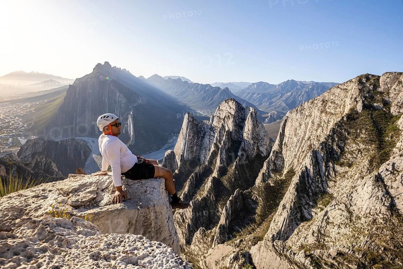 A man takes a rest on the rocky cliffs of Eagleâ€™s Nest in Monterrey, Mexico, after practicing mountaineering and rappelling, enjoying the stunning mountainous view