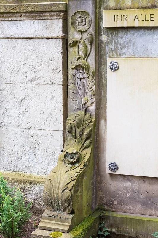 Sandstone column decorated with poppy plant, Dresden Forest Cemetery, Saxony, Germany