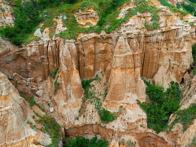 Close-up of erosion rocks with green vegetation in a hilly landscape, aerial view, Râpa Ro?ie, Rapa Rosie, Red Gorge, Nature Reserve, Sebe?, Alba County, Transylvania, Romania