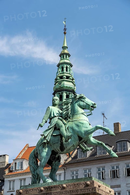 Equestrian statue of Absalon and the tower of St Nicholas Church on the central square Højbro Plads in Copenhagen, Denmark