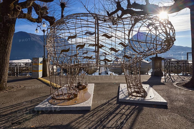 Christmas decoration, illuminated metal figure, lakeside promenade, lake, trees, mountains, backlight of the sun, Lake Lugano, Lugano, district Lugano, canton Ticino, Switzerland