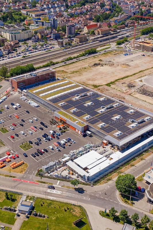 Aerial view of buildings with solar cells surrounded by an urban landscape, PV system at OBI Baumarkt, Mühlacker, Enzkreis, Germany