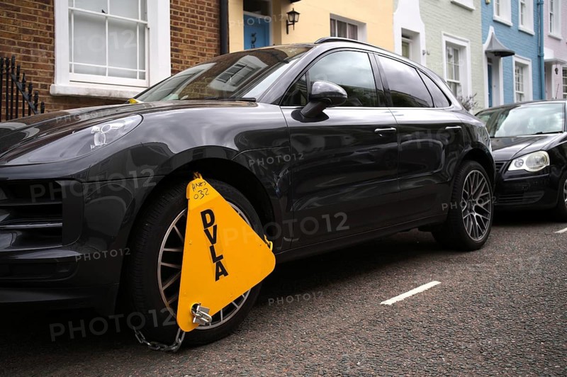 Yellow wheel claw, parking claw, the DVLA Driver and Vehicle Agency, an Porsche, anti-theft, prevention and protection against theft, Notting Hill, Kensington, London, England, Great Britain, Great Britain