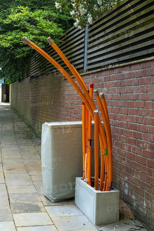 Distribution box in which empty conduits for fibre optic cables arrive and are connected, in which the actual fibre optic cable is later blown in and connected to the respective house connection. Essen, North Rhine-Westphalia, Germany