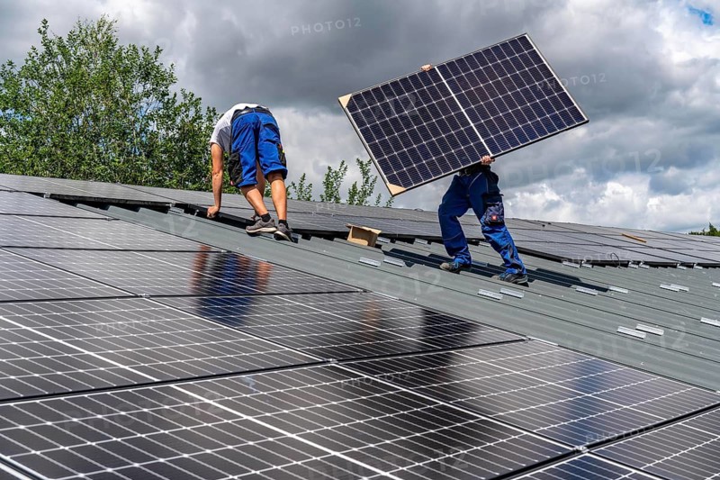 Installation of solar modules on the roof of a barn on a farm, over 210 photovoltaic modules are installed on the roof, North Rhine-Westphalia, Germany