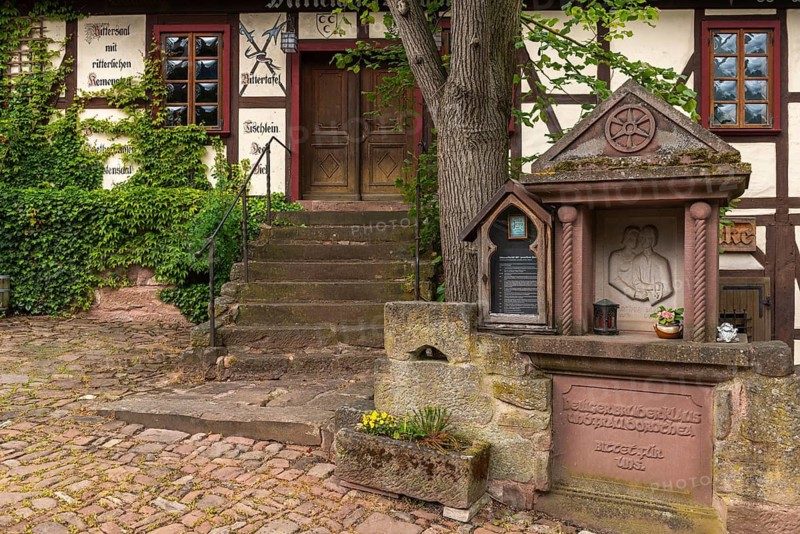 Historic inn and village inn Klausenhof below the Hanstein castle ruins on the German Sausage Route, half-timbered house, information board, anvil, memorial plaque to the god-fearing priest Niklaus von Flüe (15th century), Bornhagen, Eichsfeld district, Thuringia, Germany