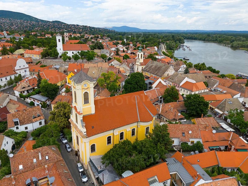 Cityscape with a centrally placed church surrounded by red roofs and a river nearby, aerial view, St. Peter and Paul Church, Szentendre, Sankt Andrä, Danube River, Pest County, Central Hungary Region, Hungary