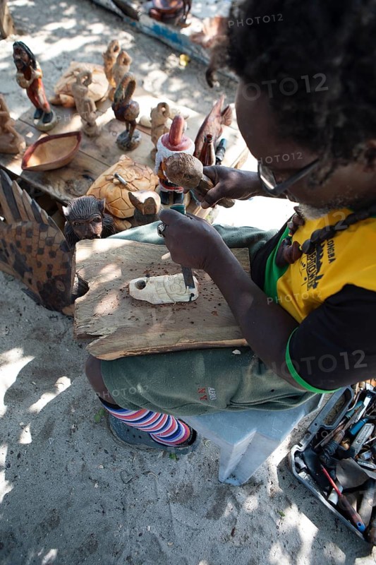 Jamaican man, 61 years old, carves a Santa Claus figure on Booby Cay Island, Negril, Westmoreland Parish, Jamaica, West Indies, Caribbean, Central America