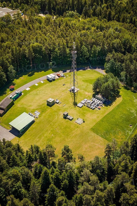 Close-up of a radio tower surrounded by thick forest and an open meadow, bunker complex, Calw, Germany