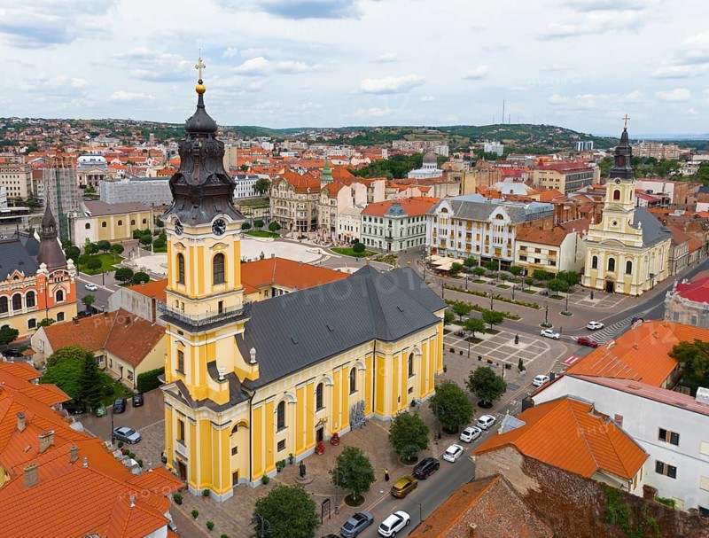Baroque church rises above the surrounding urban landscape with historic roofs, aerial view, St. Nicholas Church, Moon Church on the right, Oradea, Oradea, Bihor district, Kreischland, Transylvania, Romania