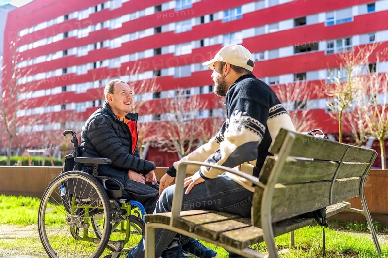 Two friends enjoying a sunny day in a vibrant urban park, sharing laughter and stories while embracing the spirit of togetherness and connection