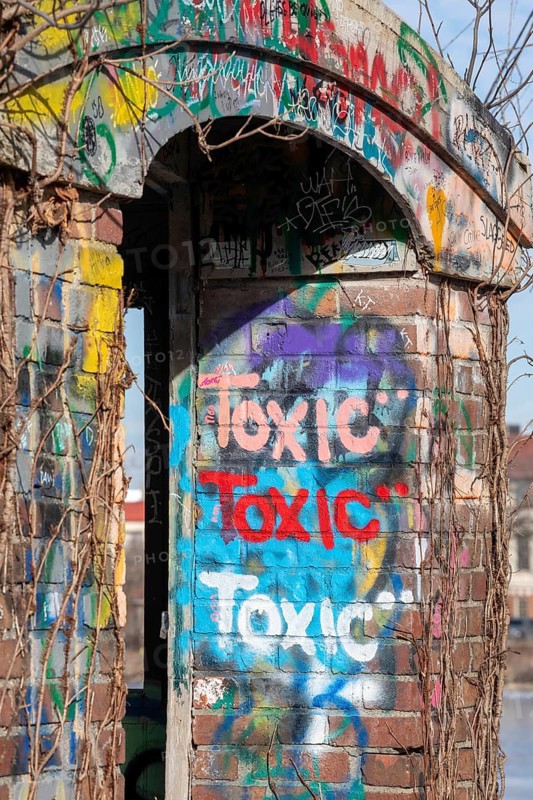 Detroit, Michigan - Graffiti reading toxic is painted on an abandoned pedestrian bridge on Belle Isle, a state park in the Detroit River