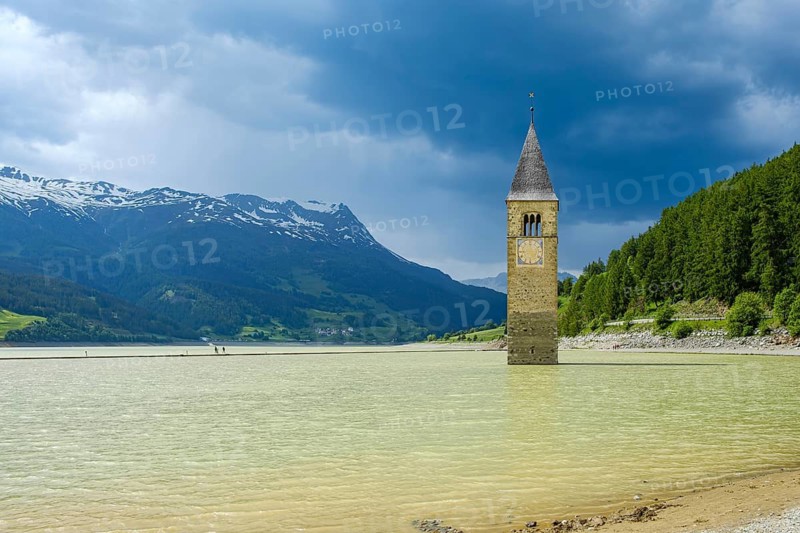 Bell tower of the former parish church of St Catherine in the sunken village of Alt-Graun in Lake Reschen in Vinschgau, South Tyrol, Italy