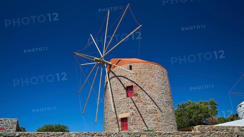 Stone windmill with blue roof and red window under clear blue sky, Trypiti, Tripiti, village, Milos, island, Cyclades, Greek Islands, Greece