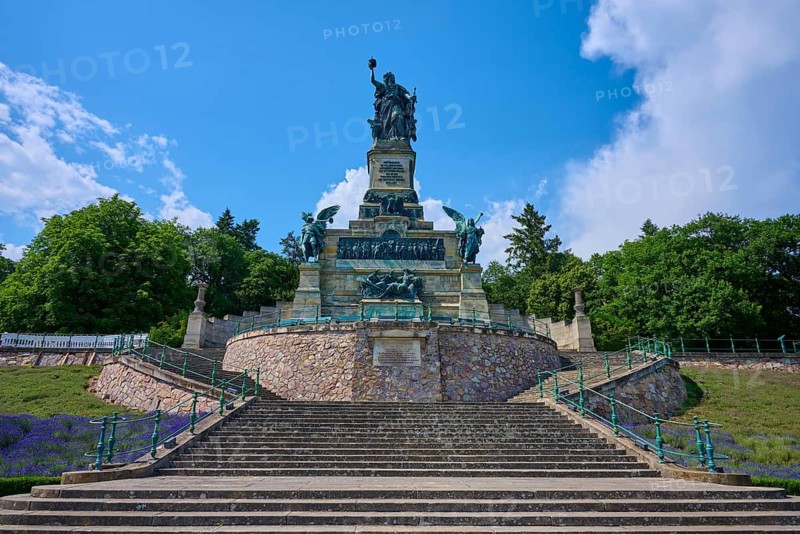Monumental statue on stepped landscape, framed by trees and sky, Niederwalddenkmal, Rhine, Rüdesheim am Rhein, Rheingau, Hesse, Germany