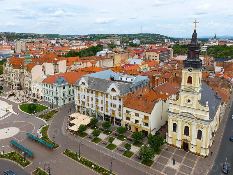 Church tower dominates an old town with red tiled roofs and urban architecture, aerial view, center palace of Adolf Moskovits and sons, Moon Church on the right, Piata Unirii, Unity Square, Oradea, Oradea, Bihor district, Kreischland, Transylvania, Romania