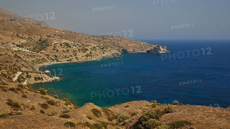 Rocky coastline overlooking calm, deep blue waters and surrounding hills, Amari Basin, Amari, Central Crete, Greek Islands, Greece