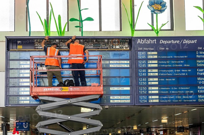 Technicians working on an electronic information board, display board for train connections at Düsseldorf Central Station, North Rhine-Westphalia, Germany
