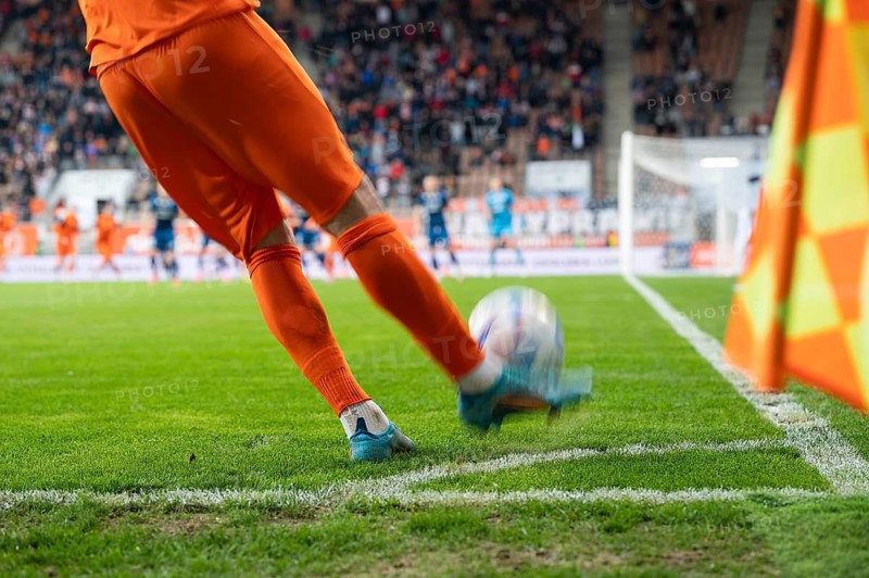 Footballer takes the corner. Detail of player's legs and the ball during soccer match in Lubin, Poland