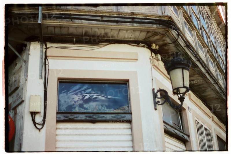 A quaint vintage bakery with a charming storefront featuring rustic architectural details, inviting passersby to step inside and enjoy freshly baked treats reminiscent of a bygone era