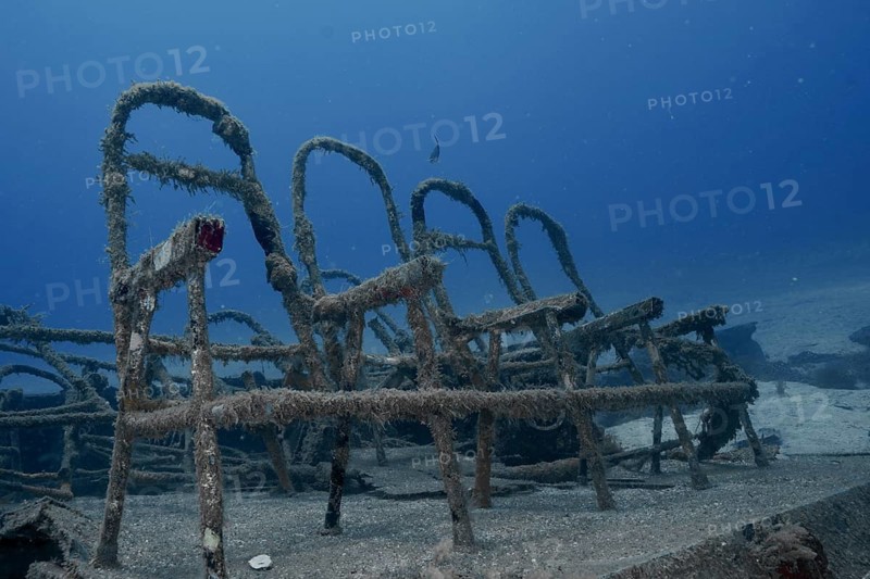 Dark underwater view of rusted ferry benches at the bottom of the sea, meteor wreck dive site, Russian hydrofoil, Arguineguin, Gran Canaria, Spain, Europe, Atlantic