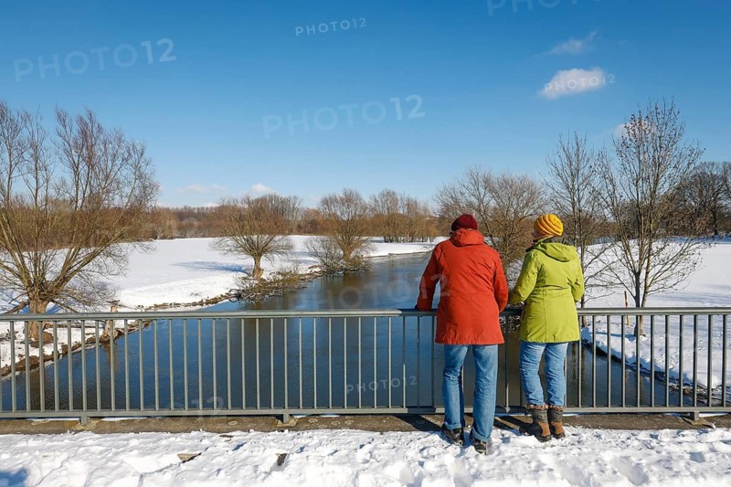 Hamm, North Rhine-Westphalia, Germany - Sunny winter landscape in the Ruhr area, ice and snow on the river Lippe, walkers standing on a bridge