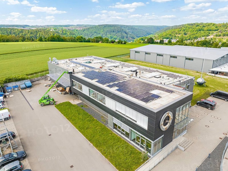 Modern office building with solar roof, embedded in a green landscape, PV assembly, Perrot company, Calw, Germany